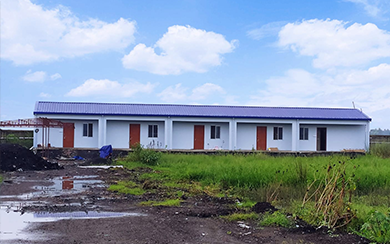 Row of LGSF prefabricated labour housing units with pitched roofs on a cleared site
